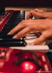 Midsection of man playing piano