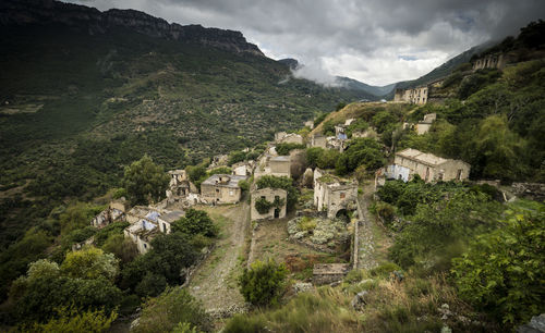 High angle view of houses and mountains against sky