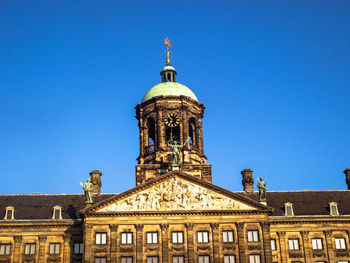 Low angle view of building against blue sky