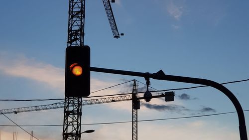 Low angle view of road sign against sky