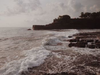 Scenic view of sea against cloudy sky