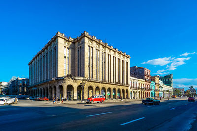 Cars on road against blue sky