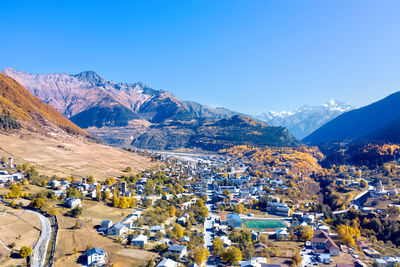 Scenic view of snowcapped mountains against clear blue sky