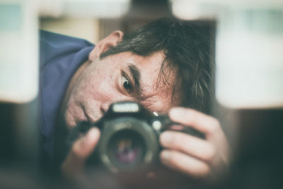 Close-up of man photographing at home