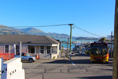 View of city street against clear blue sky