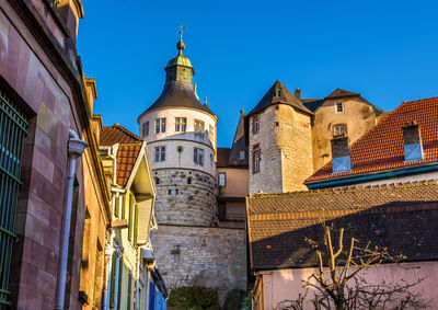 Low angle view of buildings against blue sky