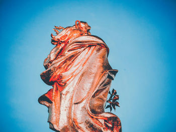 Low angle view of statue against clear blue sky