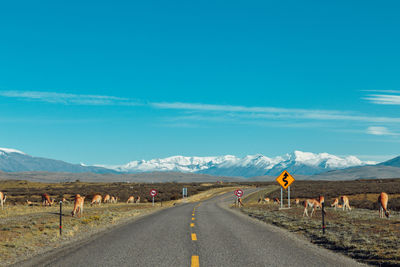 Road by landscape against sky