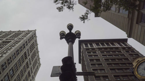 Low angle view of statue against buildings in city