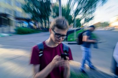 Blurred motion of man walking on road