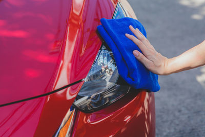 Close-up of woman holding blue umbrella