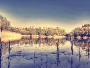 Scenic view of lake against sky during winter