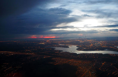 Aerial view of city against cloudy sky