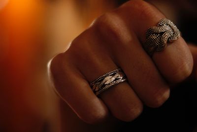 Cropped hand of woman wearing silver colored rings