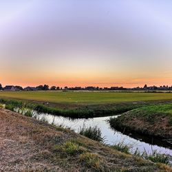 Scenic view of field against sky during sunset