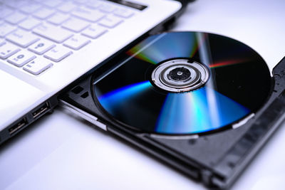 High angle view of compact disc in laptop cd player