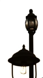 Low angle view of electric lamp against white background