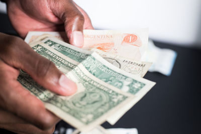 Midsection of person holding paper