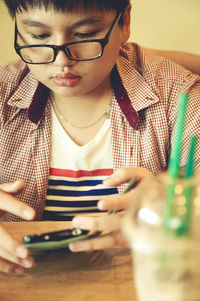 Close-up of boy using smart phone