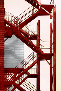 Red painted fire escape against building
