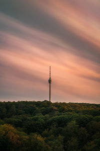 Silhouette of tower and building against sky during sunset