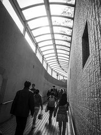 Rear view of people walking in modern building