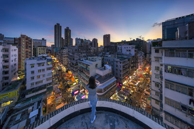 High angle view of illuminated buildings in city during sunset