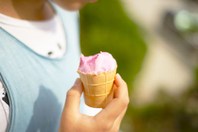 Midsection of woman holding ice cream cone