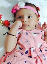 Portrait of cute baby boy on bed
