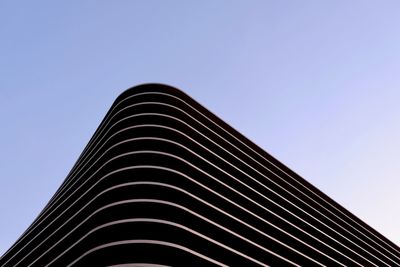 Low angle view of modern building against clear blue sky