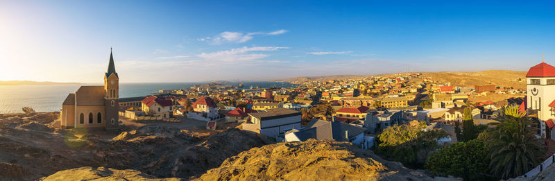 Panoramic view of buildings in town against sky