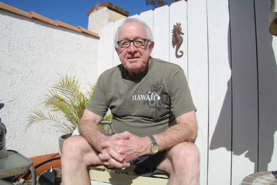 Portrait of senior man sitting on field