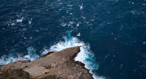 High angle view of rock formation in sea