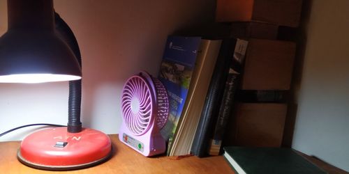 High angle view of illuminated electric lamp on table at home