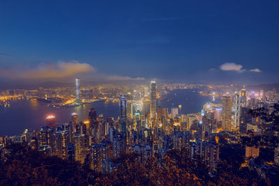 High angle view of illuminated city buildings against sky