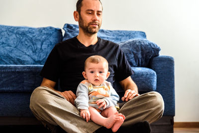 Portrait of friends sitting on sofa