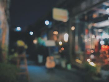 Defocused image of illuminated city street at night