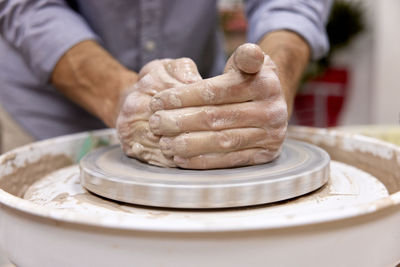 Midsection of man working at workshop