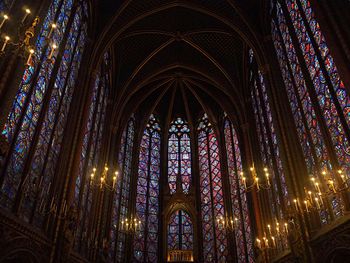 Low angle view of stained glass windows in church