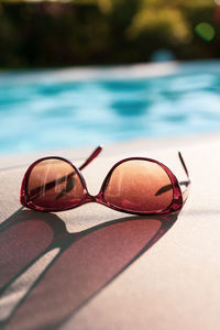 Close-up of sunglasses on swimming pool