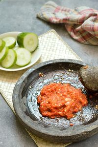 Close-up of sambal in stone mortar on table