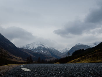 Scenic view of mountains against cloudy sky