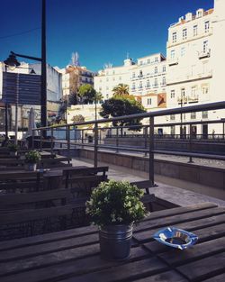 Swimming pool in city against clear sky