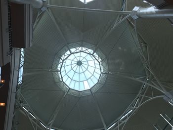 Low angle view of skylight seen through ceiling in building