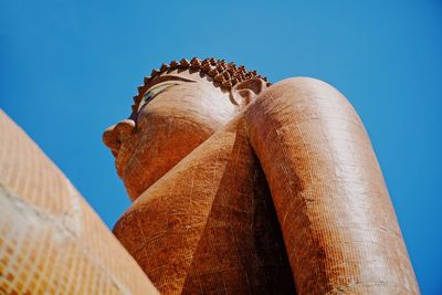 Low angle view of statue against blue sky