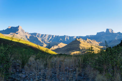 Scenic view of mountains against clear blue sky