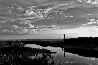 View of calm sea against cloudy sky