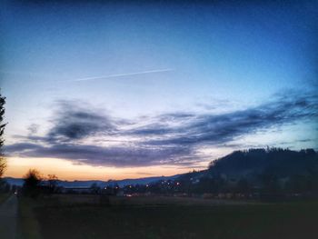 Silhouette landscape against sky at sunset