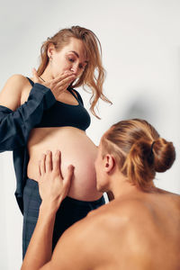 Side view of young woman exercising at home