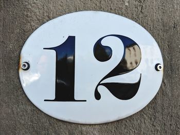 High angle view of sign on table against wall